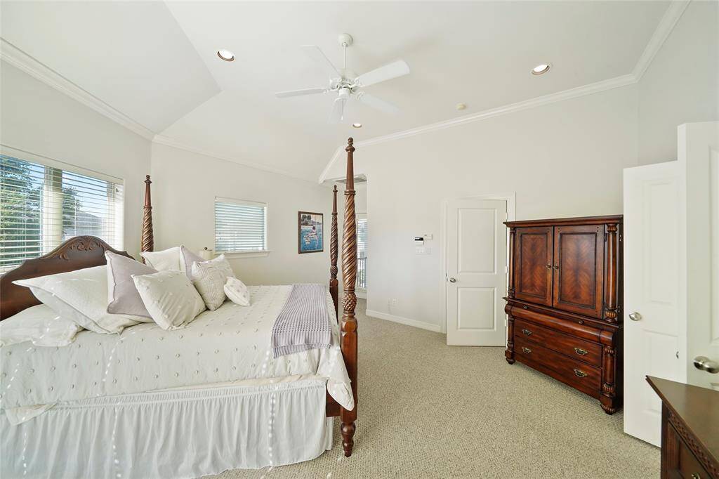 The spacious master bedroom has a vaulted ceiling and beautiful crown molding.