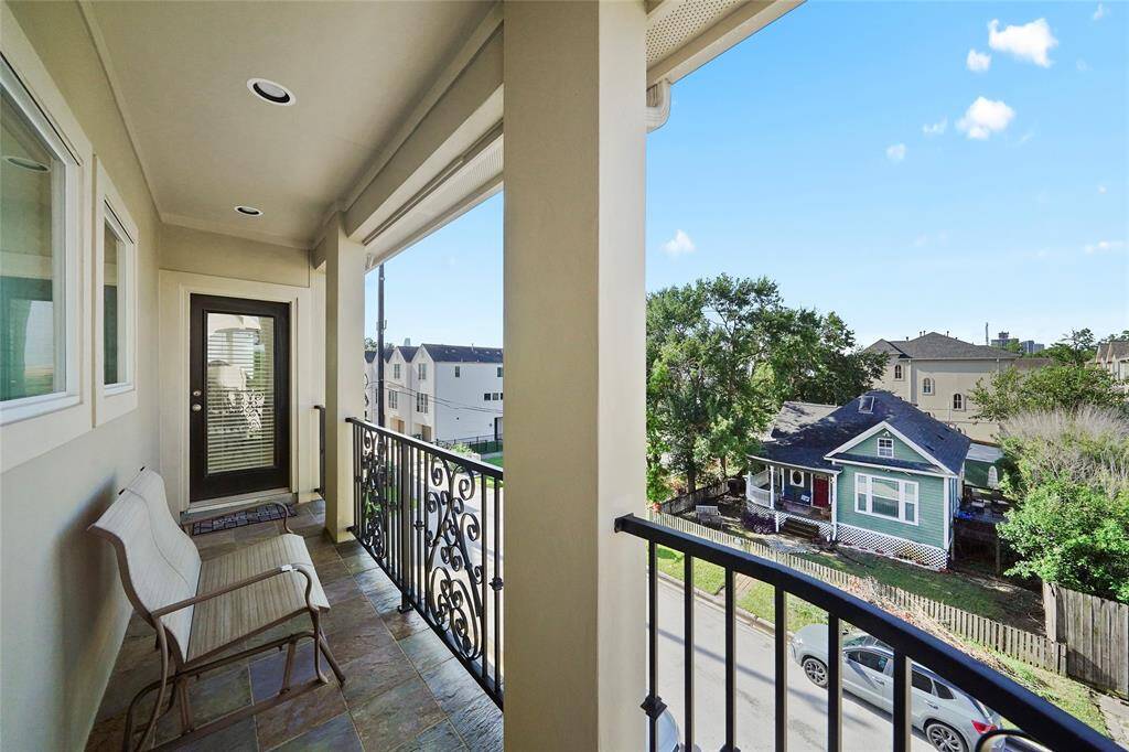 Another view of the neighborhood from the third floor balcony. The door leads into the master bedroom.