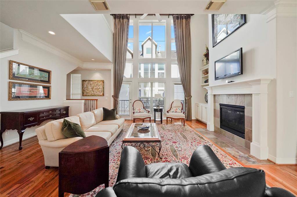 When you walk up to the second floor this is what you will experience. A wall of windows, beautiful oak floors, a two story ceiling and a gas long fireplace.