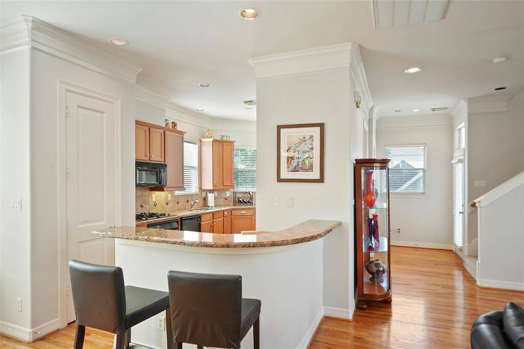 The living area opens directly to the kitchen and the breakfast bar with its granite counters.