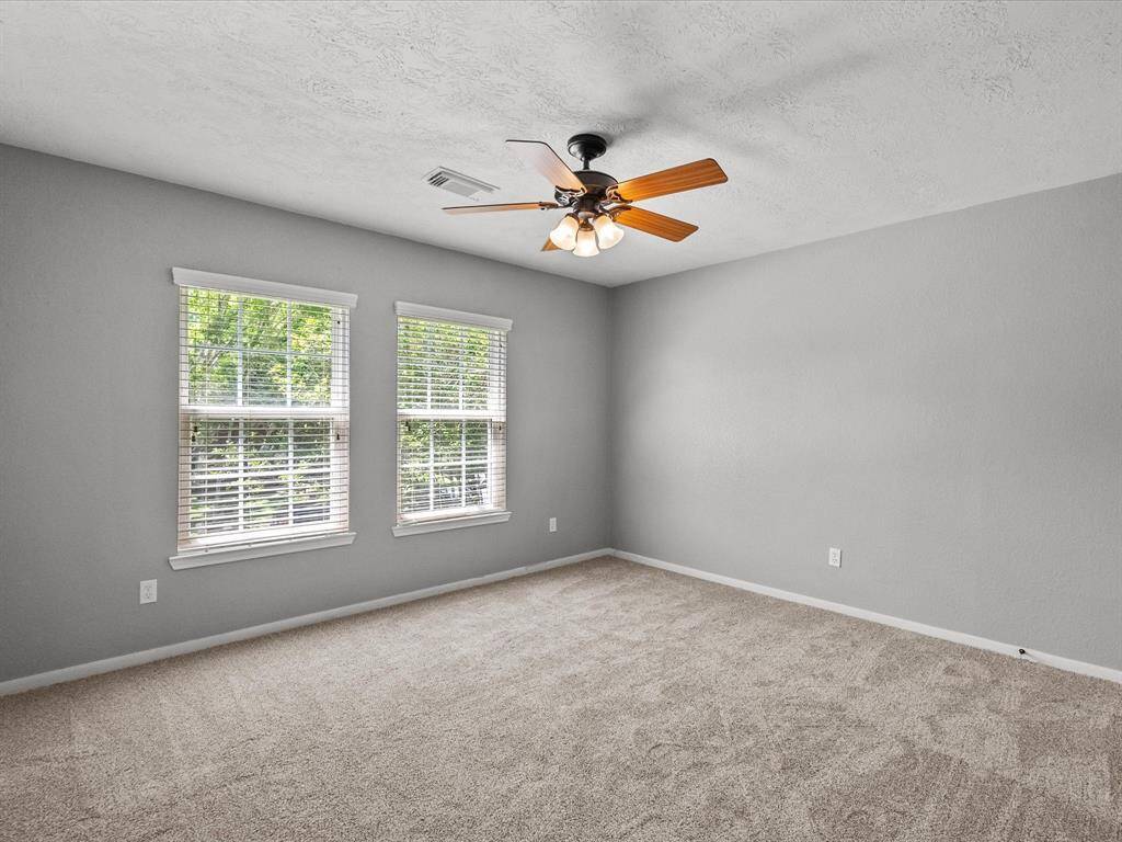 Spacious room with large windows for natural light.