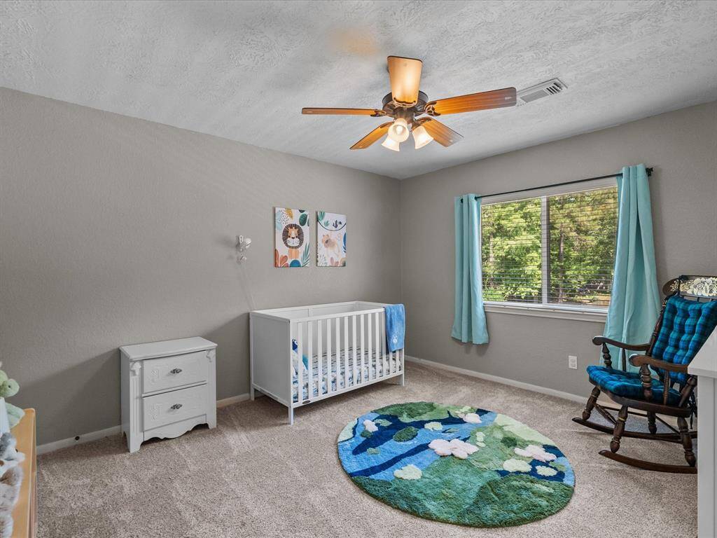 This bedroom faces the backyard and has plenty of natural light.