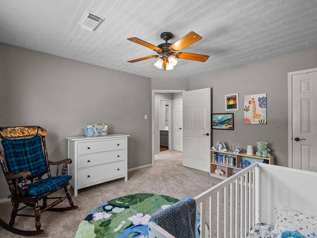 This bedroom faces the backyard and has plenty of natural light.