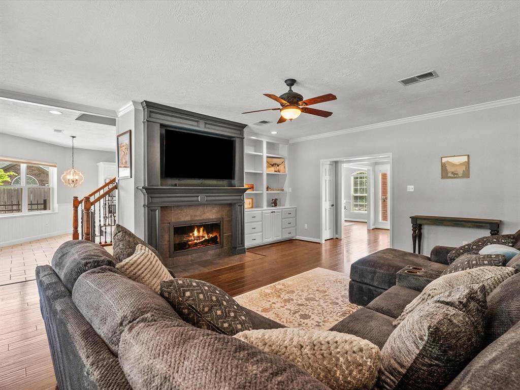 The inviting living room features a cozy fireplace and built-in book shelves for storage.