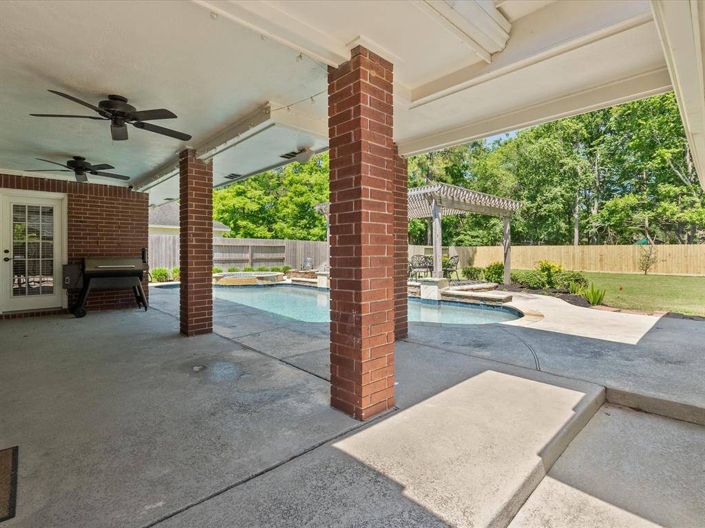 Large covered patio with ceiling fans and wired surround sound.