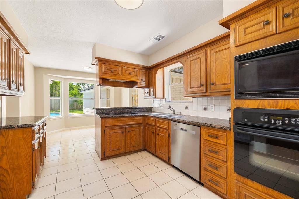 Designed for both style and function, this well-appointed kitchen features convenient pots and pans drawers, a built-in oven, and ample storage throughout. A brand-new dishwasher, installed in April 2025, adds modern efficiency to this timeless space—making daily routines a breeze.