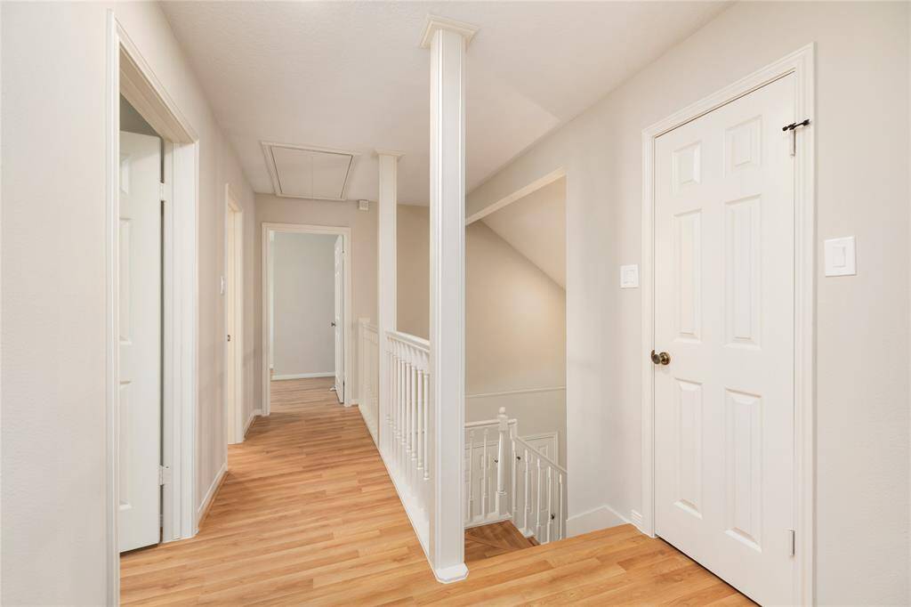 The upstairs balcony walkway offers a stunning view of the home’s entry, adding a touch of elegance and openness. A convenient closet provides additional storage space, while the bright, airy feel of the upstairs area invites you to explore further, creating a perfect blend of functionality and light-filled design.