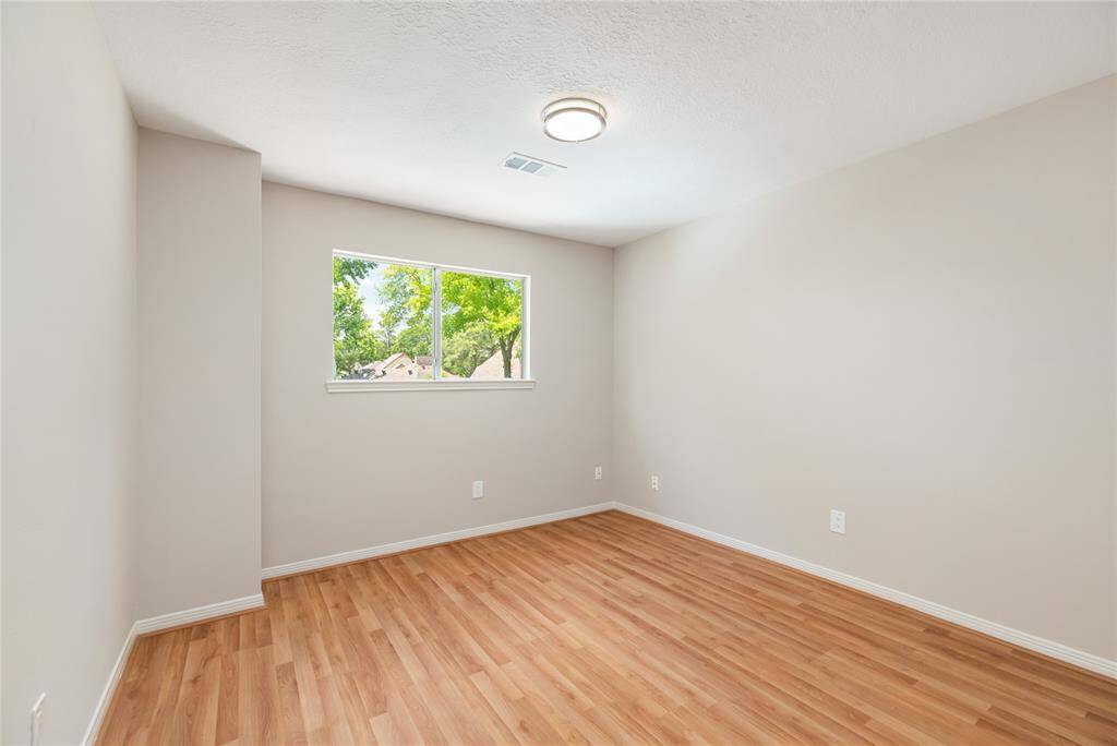 This versatile secondary bedroom offers ample space, whether you’re looking for a cozy retreat or a comfortable guest room. The room is bright and welcoming, with new light fixtures throughout the home, installed in April 2025, adding a modern touch to the space.