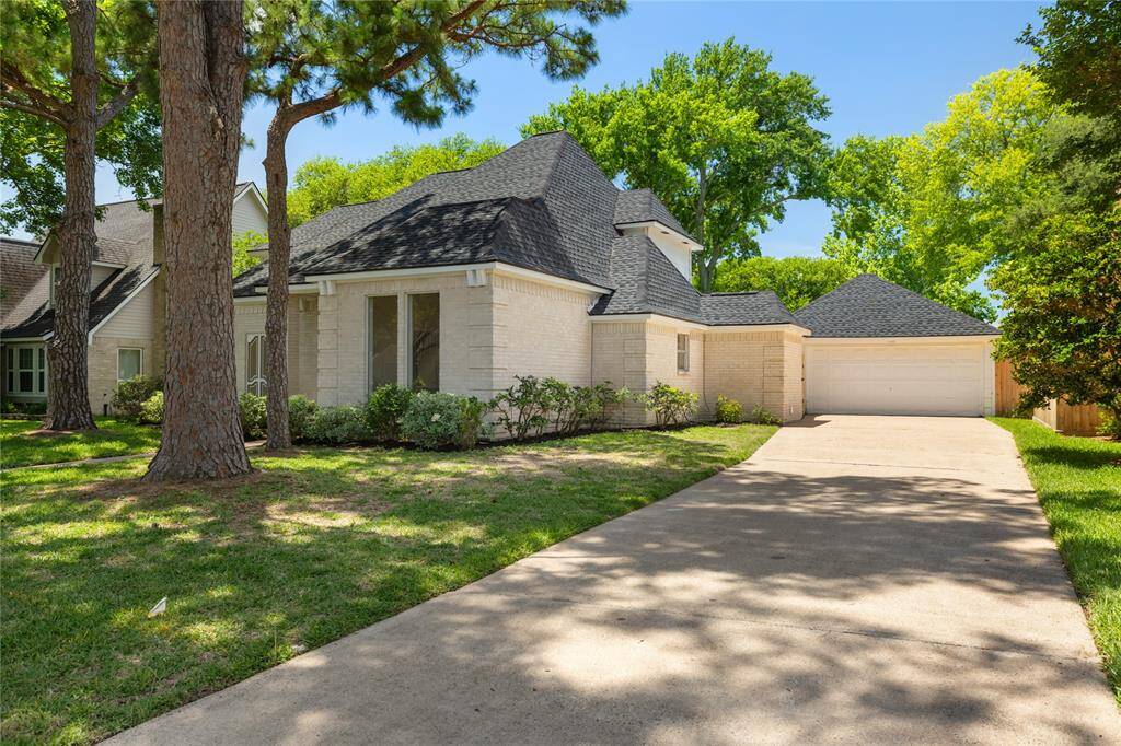 A long, private driveway leads to a detached 2-car garage, offering both convenience and extra space. Whether you're looking for secure parking or room for a workshop, this setup adds functionality and flexibility to the home’s classic charm.