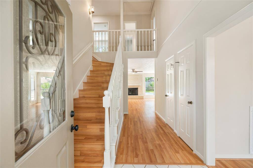 Step inside to a warm and welcoming entry, where beautiful wood-look floors set the tone for the rest of the home. A peek at the staircase and upstairs balcony hints at the spacious layout, while the open feel invites you to explore further. The entire interior of the home was freshly painted in April 2025, offering a crisp, updated look throughout.