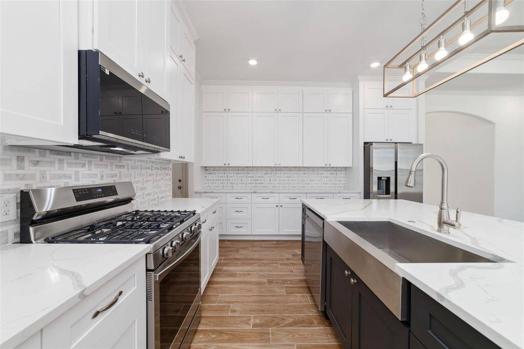 Functional layout for easy cooking and clean up including a stainless farmhouse sink.