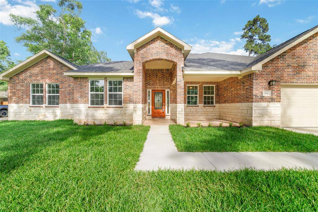 Beautiful front exterior with covered porch and upgraded door.