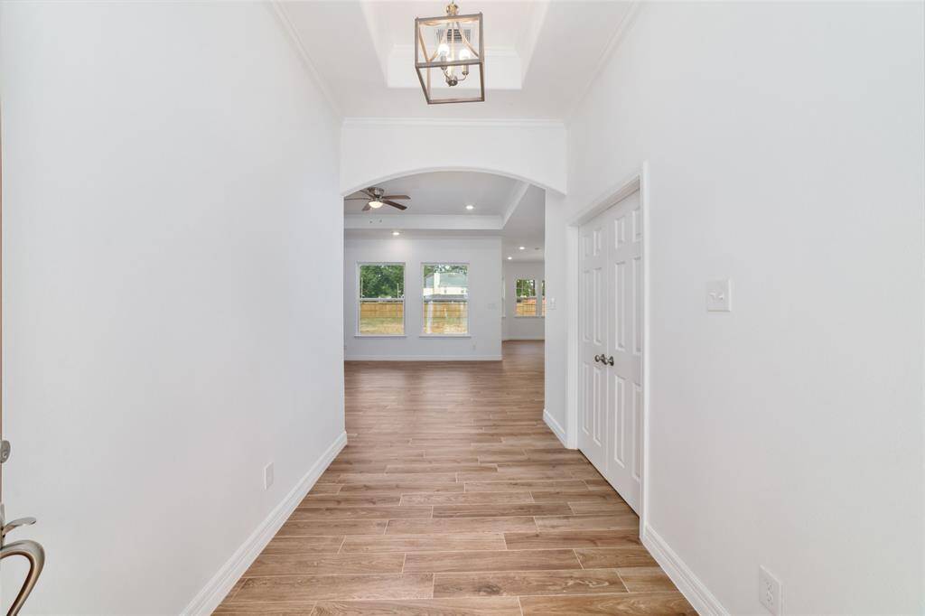 Front entryway with high ceilings. Office door to the right. Directly ahead is the main living areas.