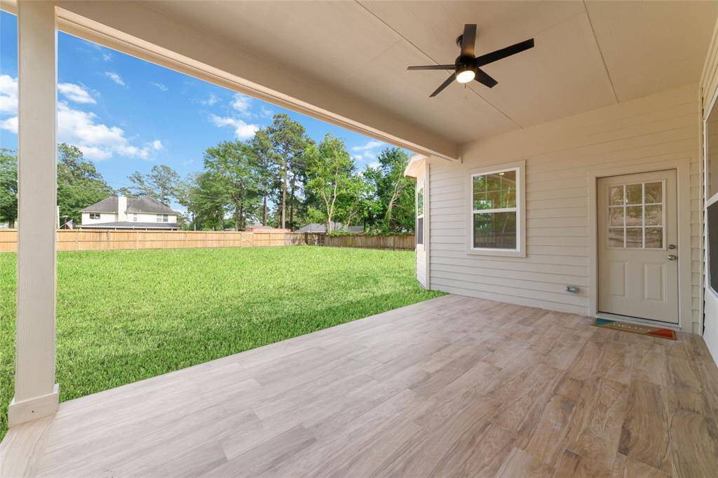 Relax at the end of the day on this expansive covered patio looking over the enormous backyard.