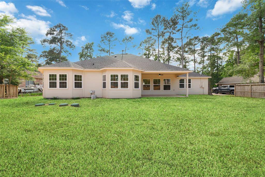 View of the back exterior of the house. This is representative of what it will look like with grass. Currently, it is mostly dirt as construction has just been completed.