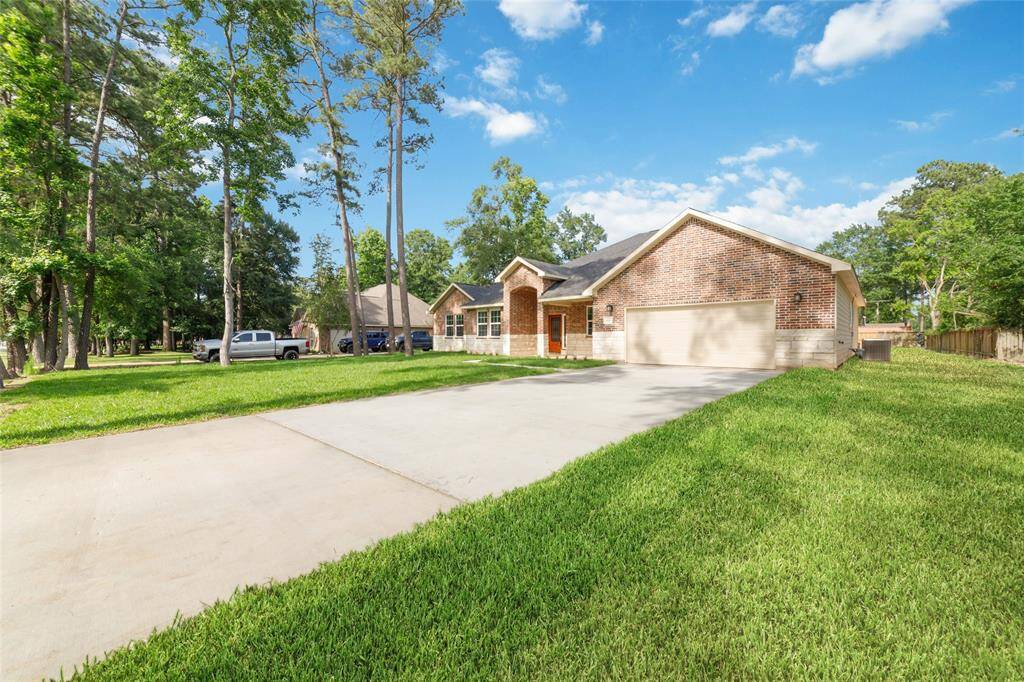 Double wide driveway leads to 2 car garage with added space around perimeter of parking area inside.