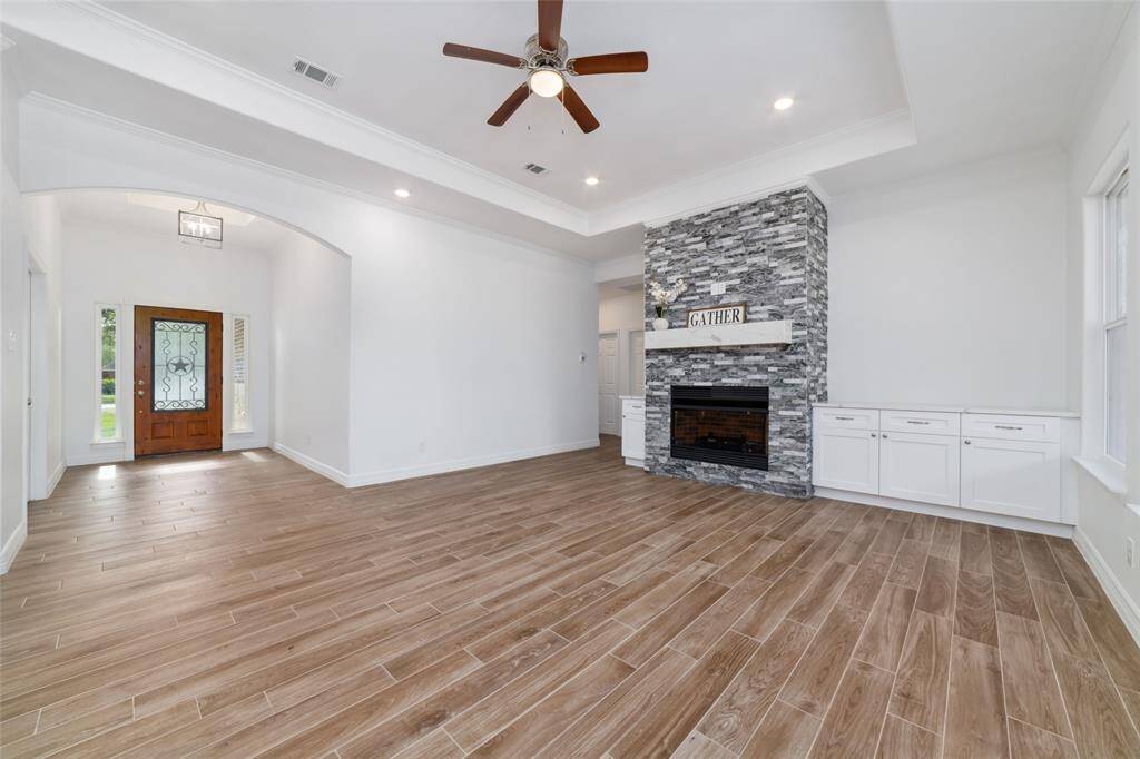 Spacious open floor plan with high ceilings. Gorgeous fireplace with stylish built-ins for added storage.