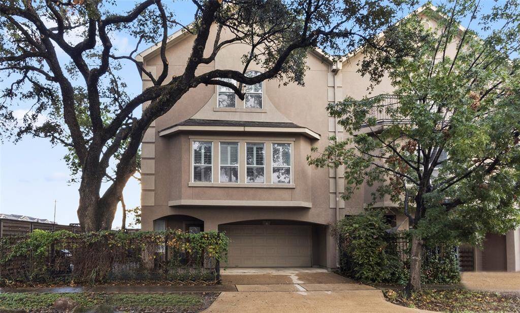 This charming three-story home features a stucco exterior with large windows and a two-car garage. Surrounded by mature trees, itswelcoming facade offers a blend ofprivacy and natural beauty. Ideal forbuyers seeking a spacious, well appointed residence.
