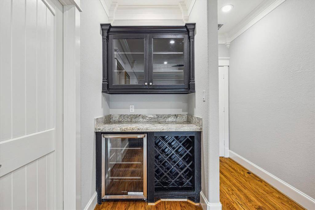 Primary bedroom even comes with a dry bar / beverage station with wine rack and mini fridge