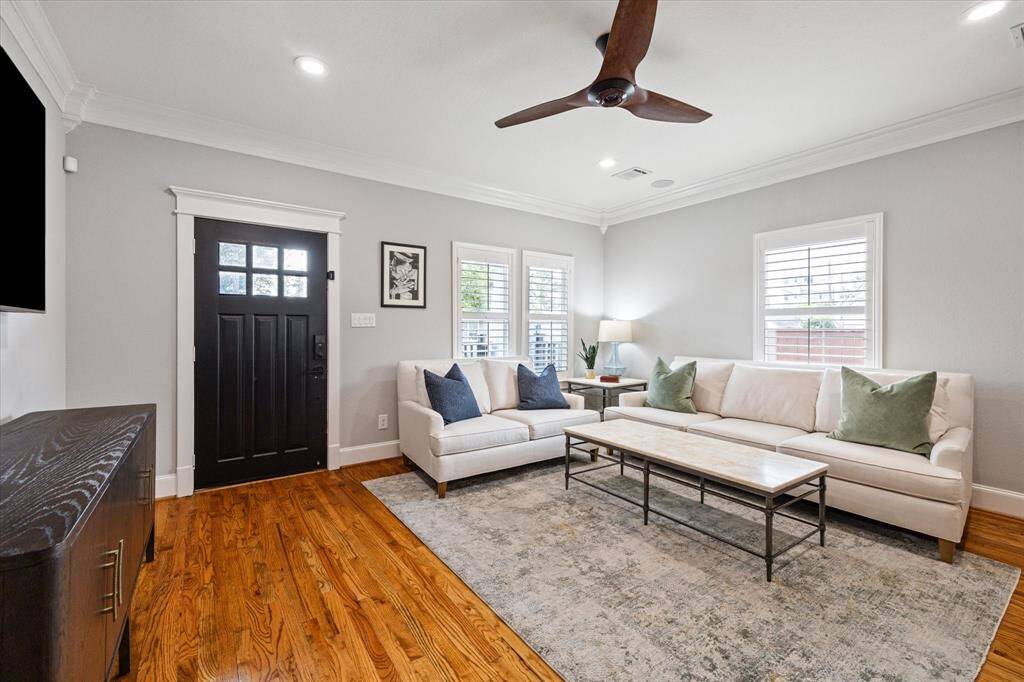 This beautiful Heights home features tall ceilings, wood floors, and double crown molding