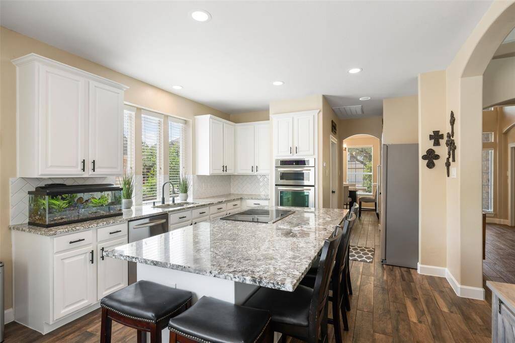 This kitchen is a chef's dream with granite countertops, KitchenAid appliances, including a microwave convection oven and a large pantry.