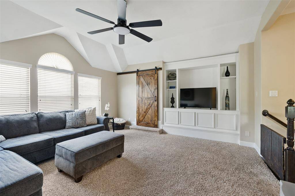 Another angle shows more built-ins and the barn door leads to extra closet space.