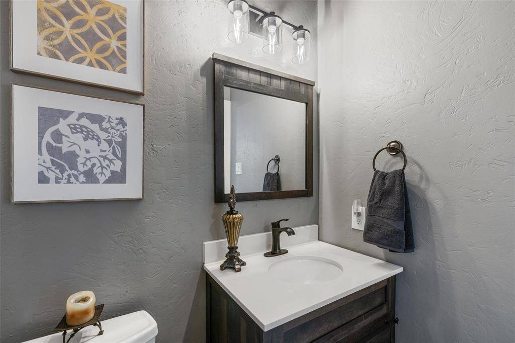 Half bath on the first floor has been updated with a new lighting fixture and oil rubbed bronze faucet and towel rack.