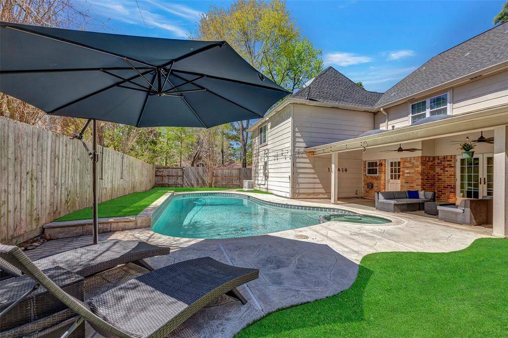 Unique pool decking and shady patio with outdoor kitchen
