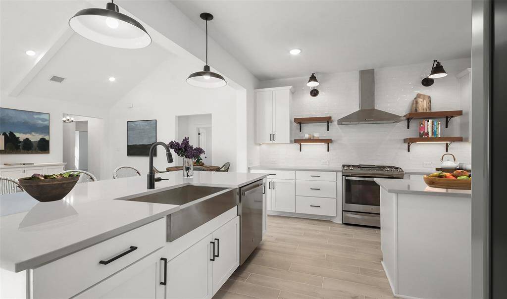 Lovely island kitchen with quartz countertops and white cabinets. (*Artist rendering used for illustration purposes only.)