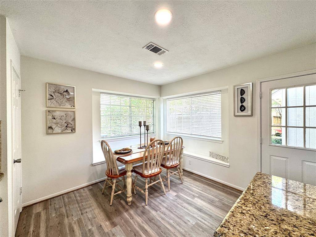 Breakfast area with window seats, pantry, and back door.