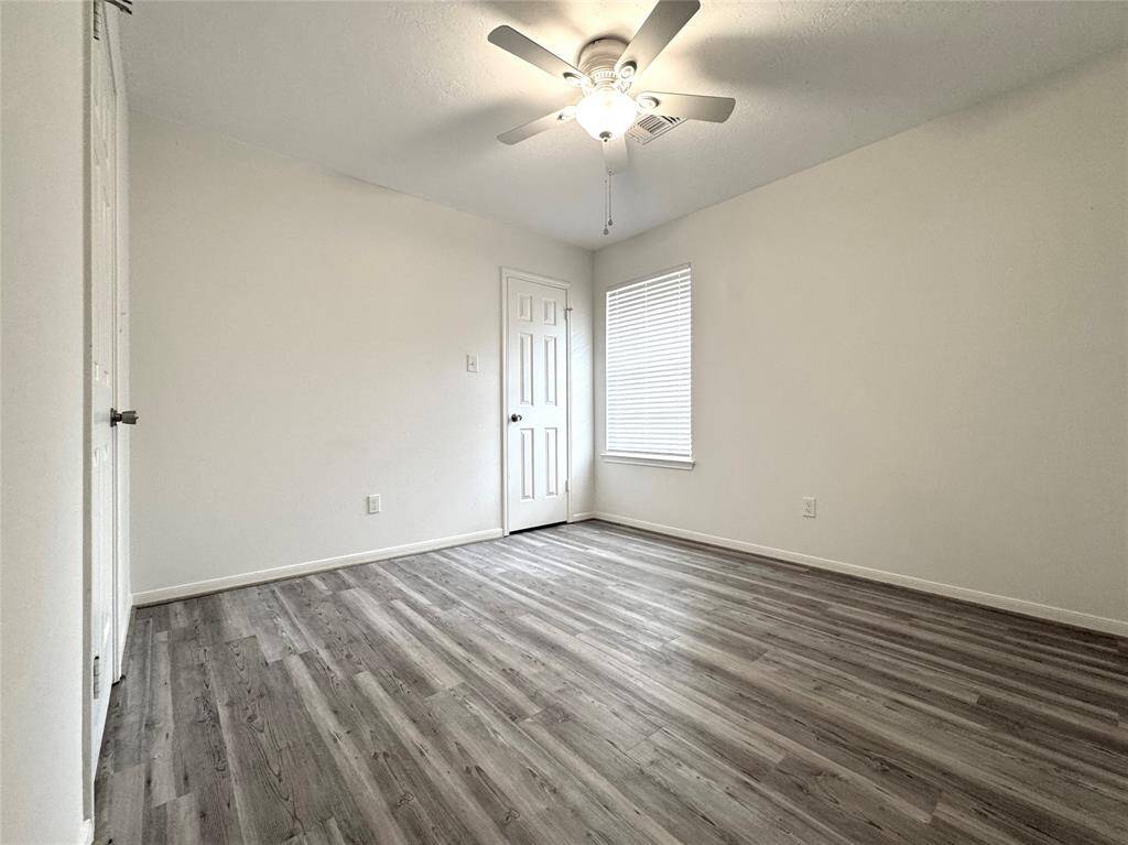 Bath 2 located outside of Bedrooms 2 and 3 (w/updated counter, mirror, faucet, and commode