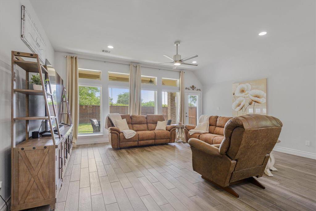 Enjoy the charm of a living area bathed in natural light from a stunning wall of windows.