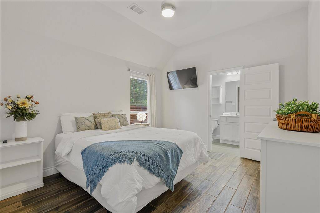 Explore the inviting second primary bedroom at the front of the home.