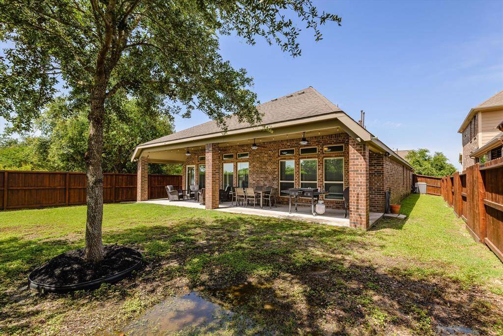 Experience serene Texas evenings on your spacious, covered back patio.