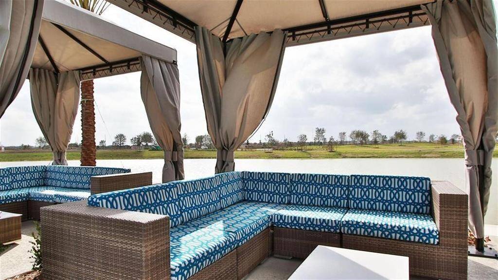 Experience resort-style relaxation at home with stunning lakeside views and luxurious outdoor seating.