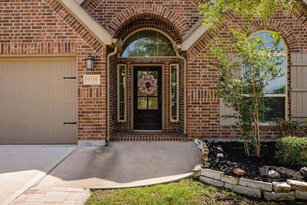 Charming curb appeal with a covered entry, frosted glass door, and stylish window shutters.