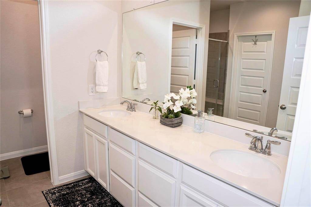 Double vanity sinks and a walk-in shower