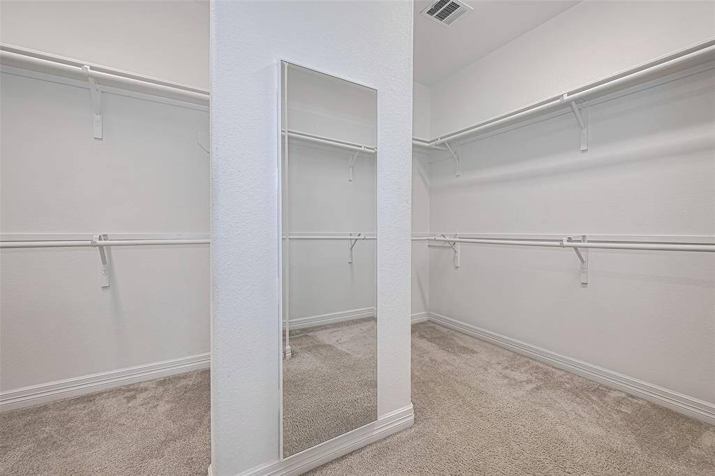 This expansive closet features generous shelving, hanging space, and built-in storage solutions, providing a designated place for all your clothing, shoes, and accessories.