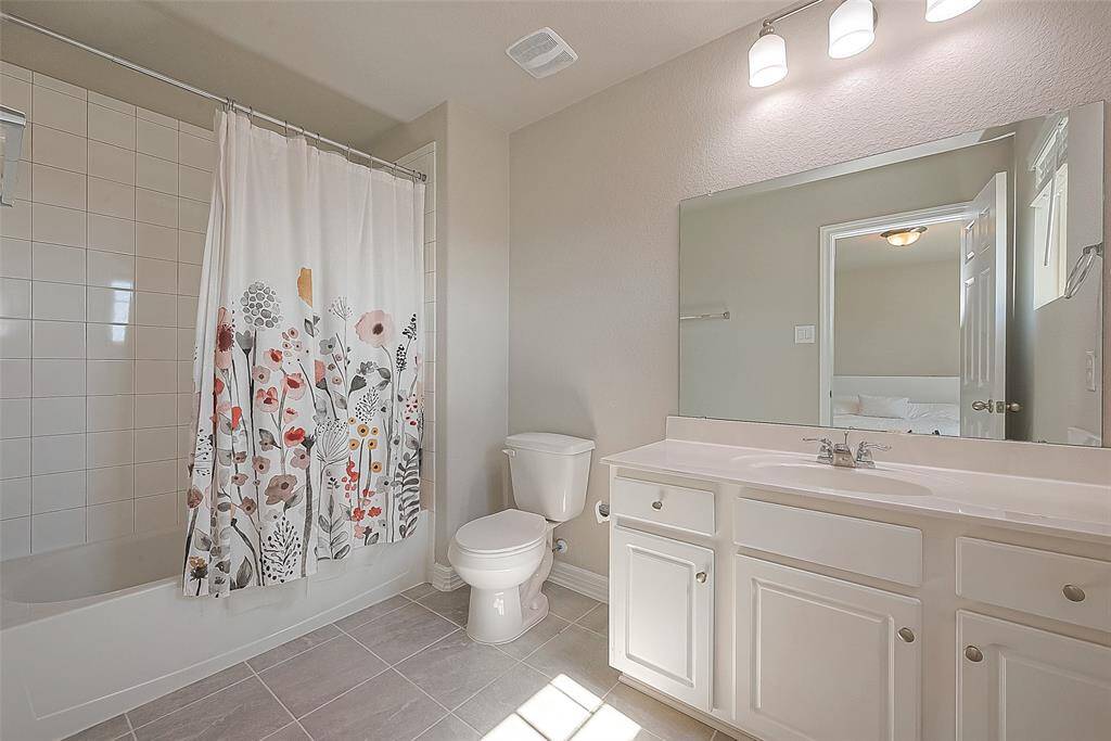 Relax and rejuvenate in the attached en-suite bathroom, offering a private oasis for pampering with its shower/tub combo and modern finishes.