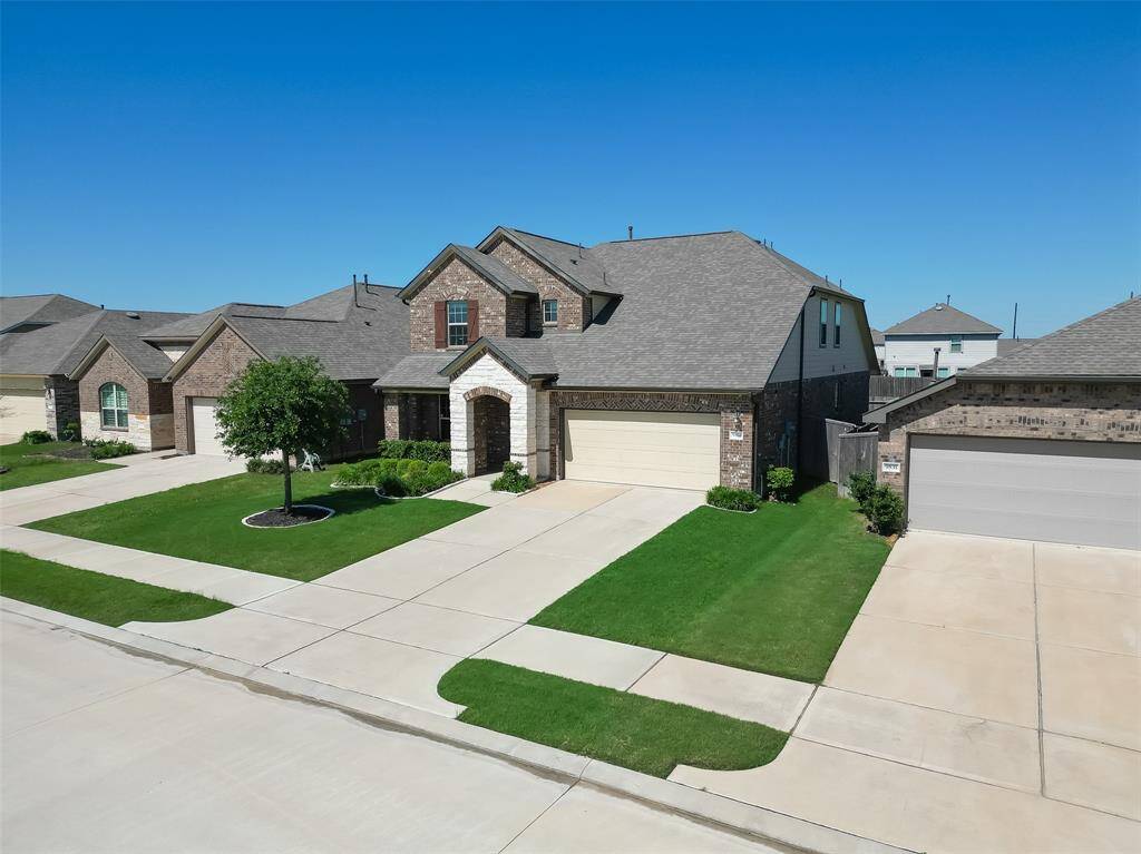 As you approach the house, you'll appreciate its classic brick and limestone facade and the neatly landscaped front yard, nestled within the serene streets of a welcoming subdivision.