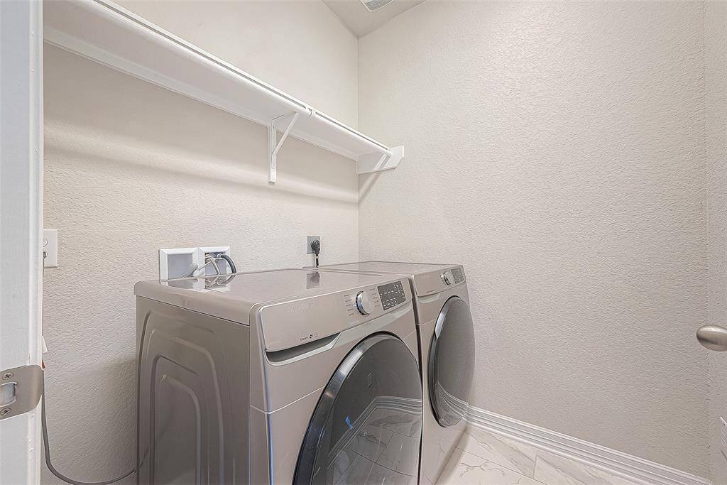 Upon entering the laundry room, you're greeted by a bright and inviting atmosphere that makes household chores feel like a breeze.