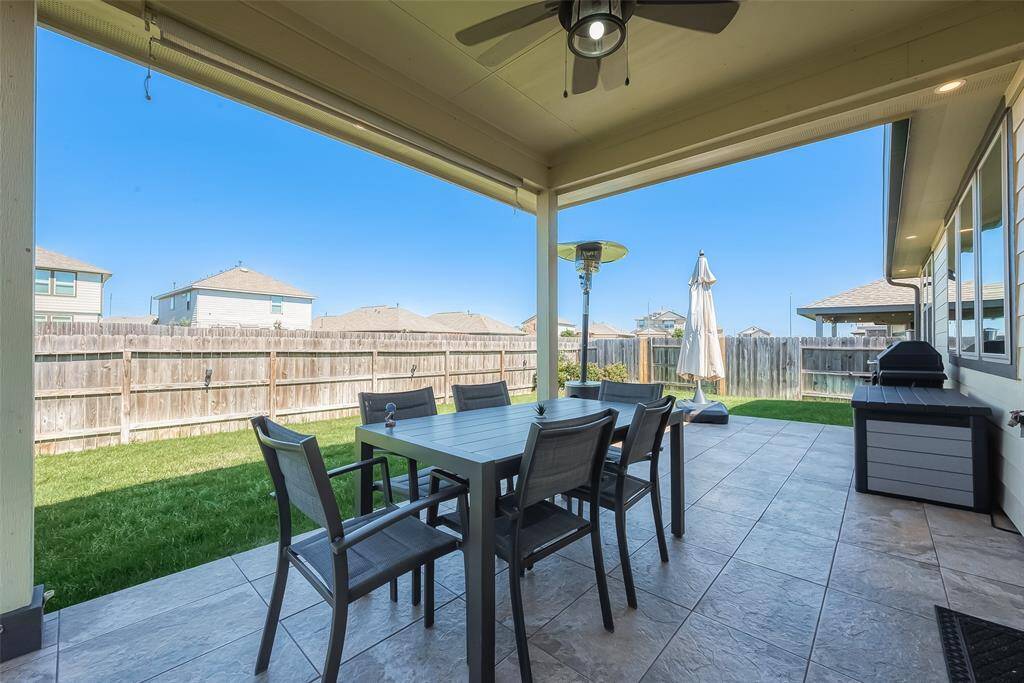The yard also includes a covered patio, offering a cozy outdoor retreat for enjoying fresh air or hosting gatherings.