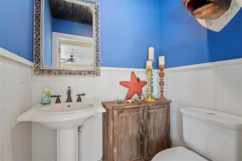 Neat nautical themed pool bathroom is just steps from the pool and outdoor entertainment area... no need to track water into the house!