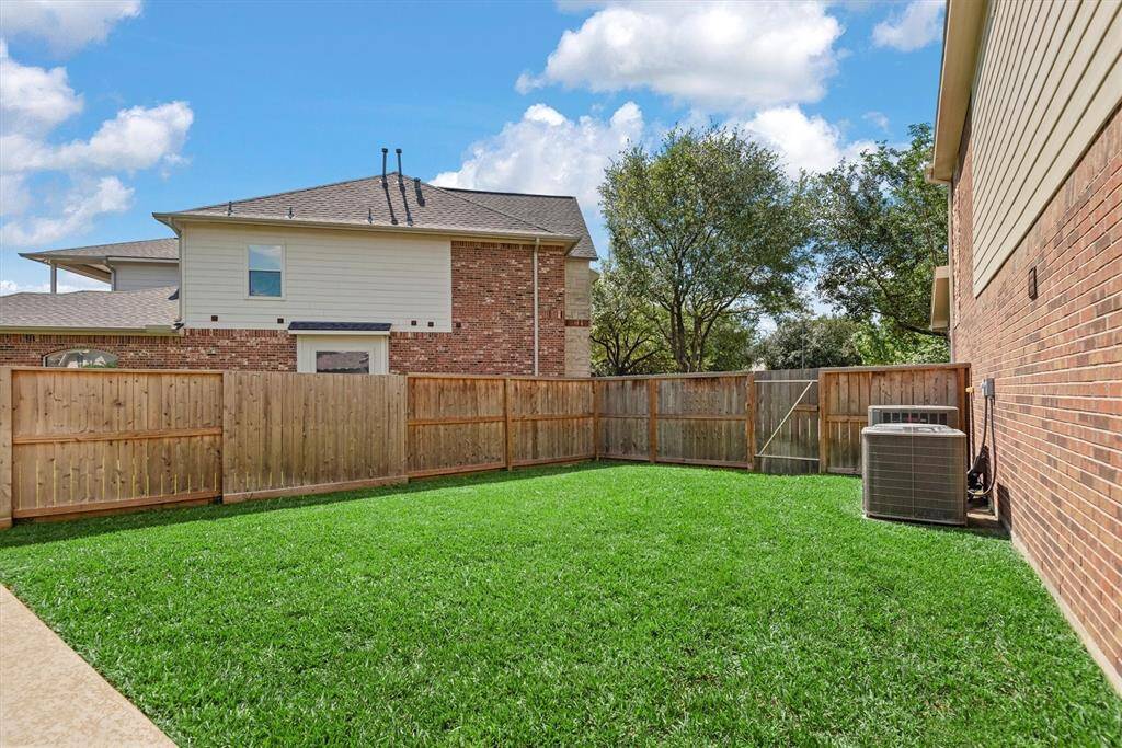 Fantastic large side yard space. This area also houses an outdoor shower and large storage closet.