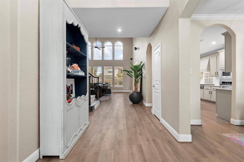The large windows offer natural light, complemented by neutral walls and warm wood-like luxury vinyl plank floors ("LVP" - designed to be scratch and water resistant).
