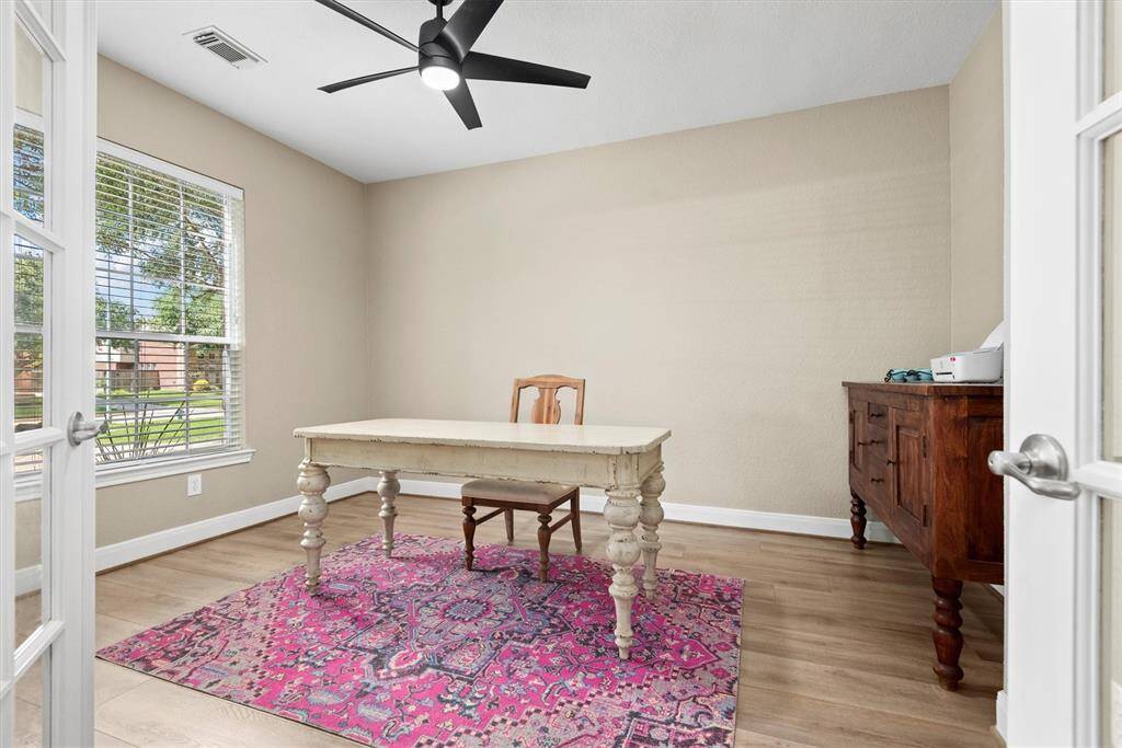 The home office with French doors creates a cozy and functional workspace.