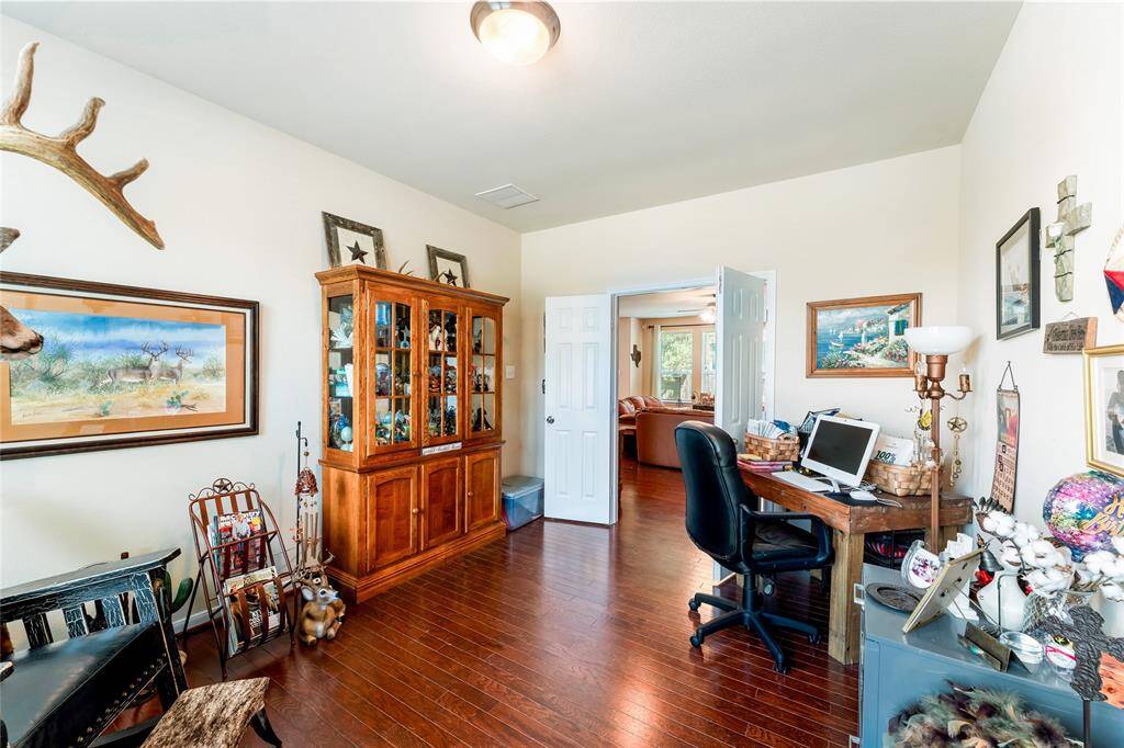 Private enclosed study with double doors, wood flooring, and abundant natural light—perfect for work, reading, or quiet retreat.