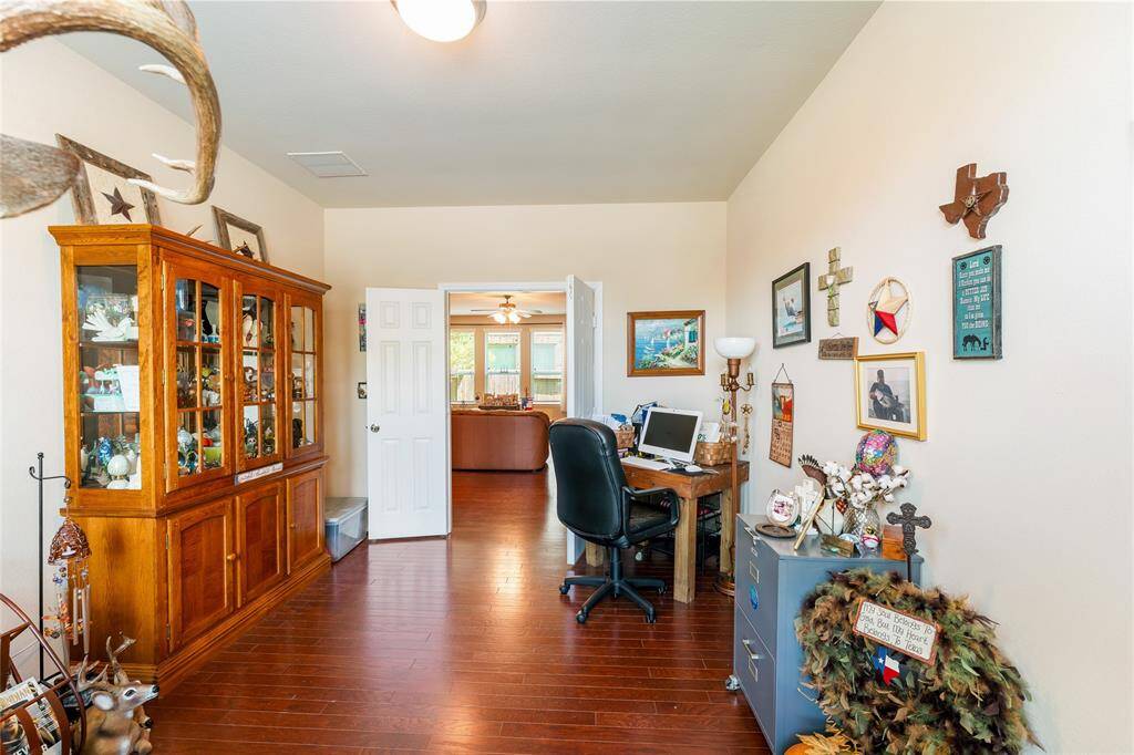 Private enclosed study with double doors, wood flooring, and abundant natural light—perfect for work, reading, or quiet retreat.