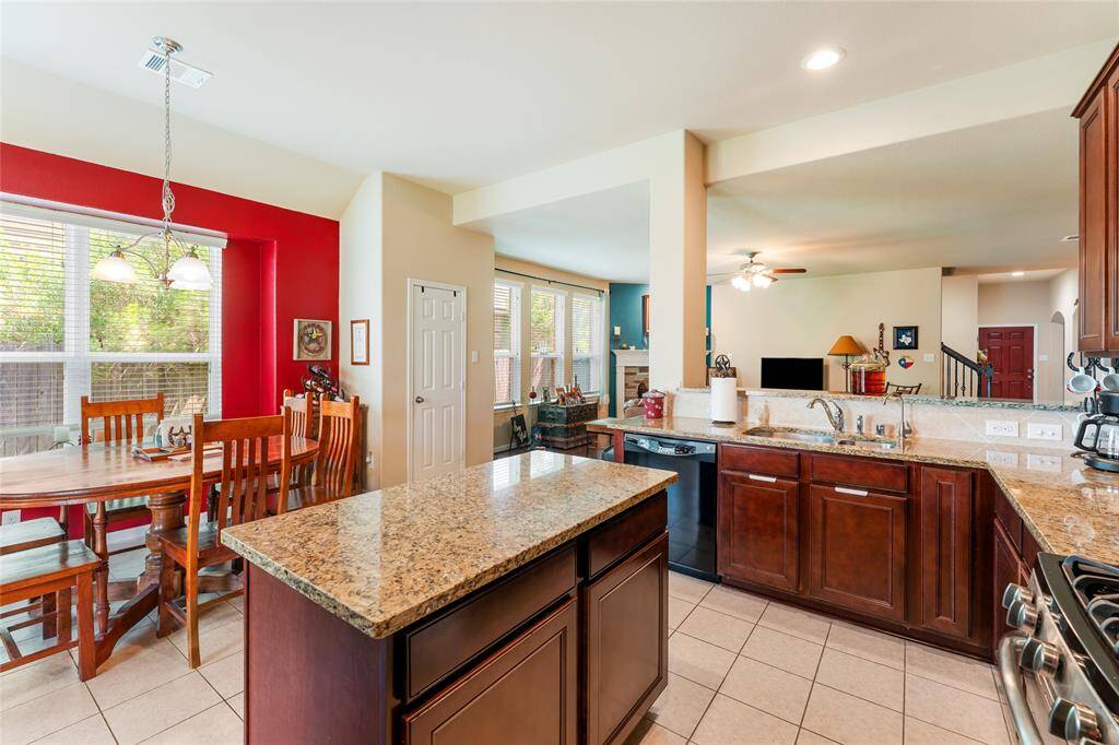 Bright and spacious kitchen with ample counter space, a large island, and plenty of room for a dining table, whether large or small, plus a brand-new microwave and 2021 Whirlpool fridge that stay with the home.