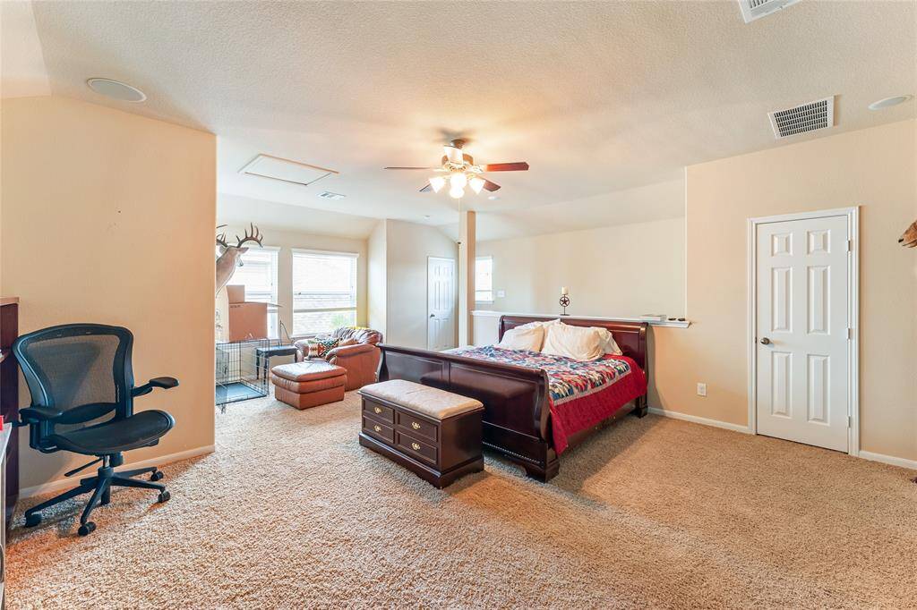 Spacious upstairs game room or flex space, featuring a full bath, closet, and plenty of natural light from multiple windows, with recessed lighting and a ceiling fan for added comfort.